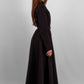 Woman wearing a long sleeve modest maxi dress in black for graduation or special occasions, with puff sleeves and elegant cotton-blend fabric.
